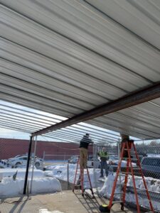 A large black metal gate installed at a residential driveway entrance by Security Fence & Construction Inc in Minneapolis, MN.