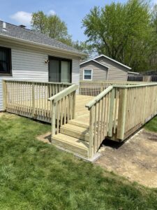A large, newly built wooden deck with stairs and railings, completed by Aaron's Handyman Service in Tucson, AZ.