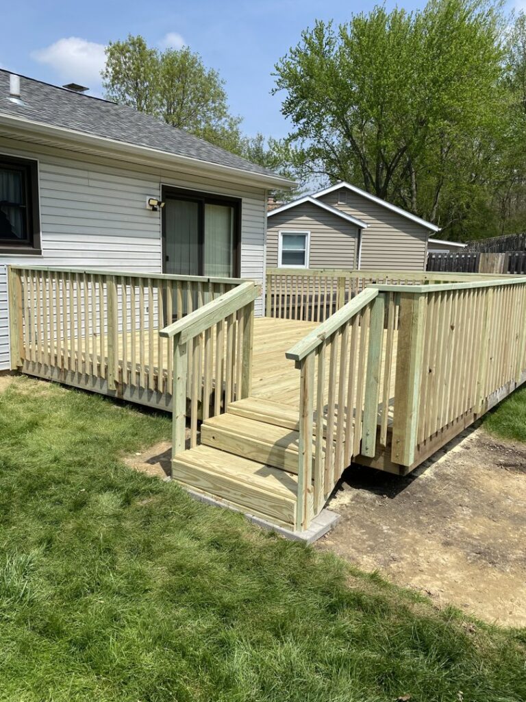 A large, newly built wooden deck with stairs and railings, completed by Aaron's Handyman Service in Tucson, AZ.