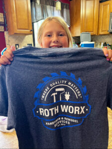 A large outdoor deck with modern black railings, built by ROTH WORX LLC in Bismarck, ND.