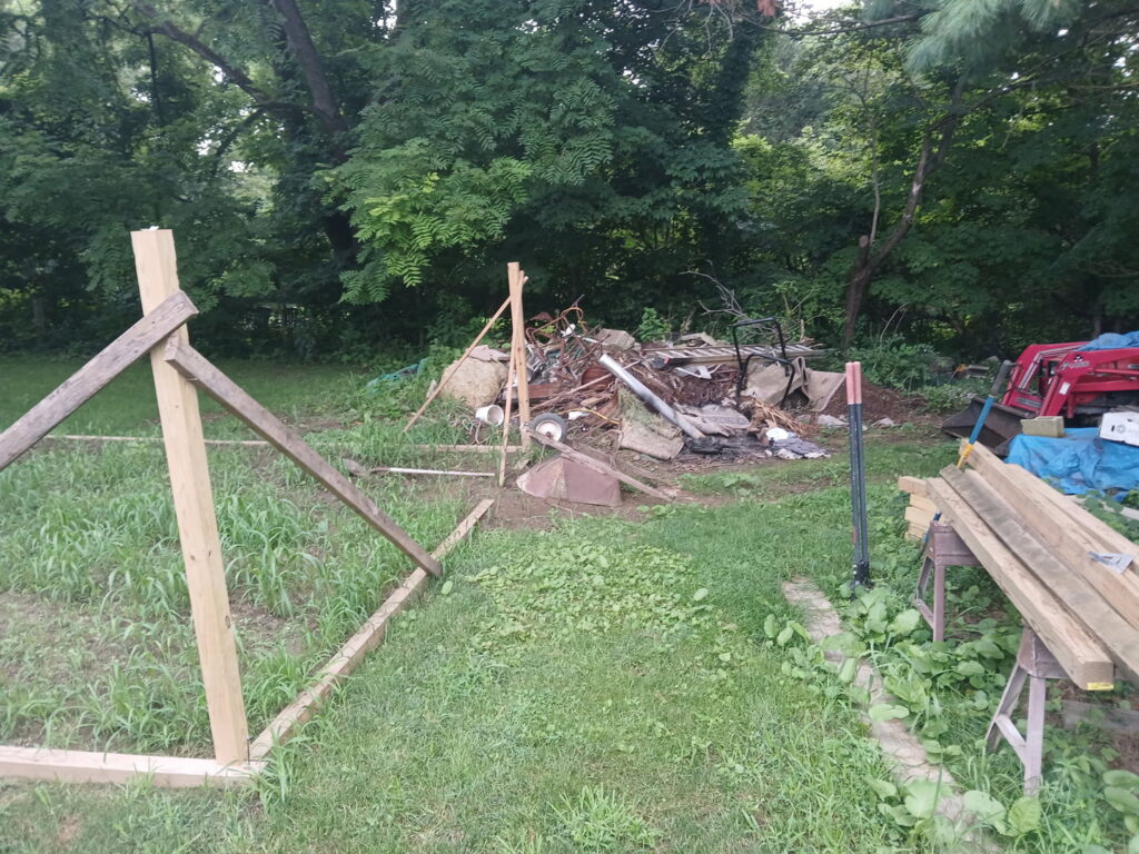 A large pile of mixed outdoor junk, including metal and wood debris, awaiting removal by JOLTZ Junk Removal in Dayton, OH.