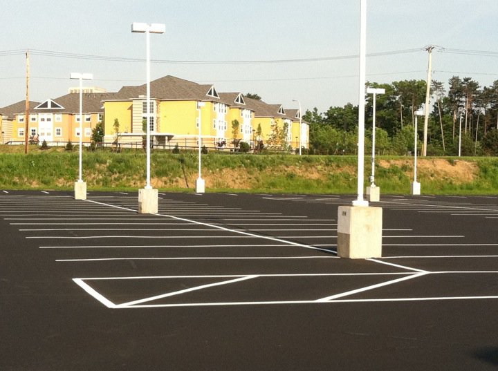 A large parking lot with freshly painted white lines completed by Empire Sealcoating in Albany, NY