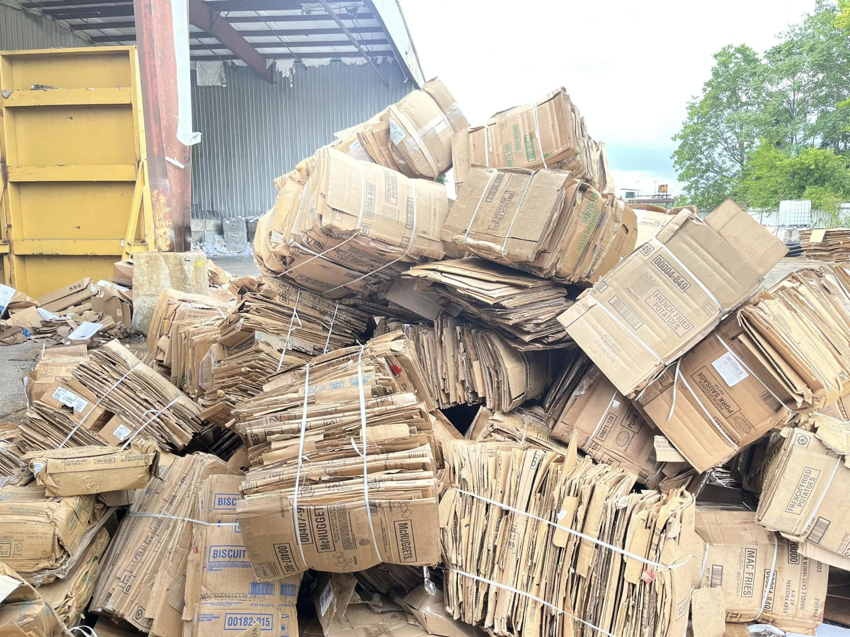 A large pile of baled cardboard boxes at a recycling facility for E&k logistics an Recycling LLC in Hoover, AL.