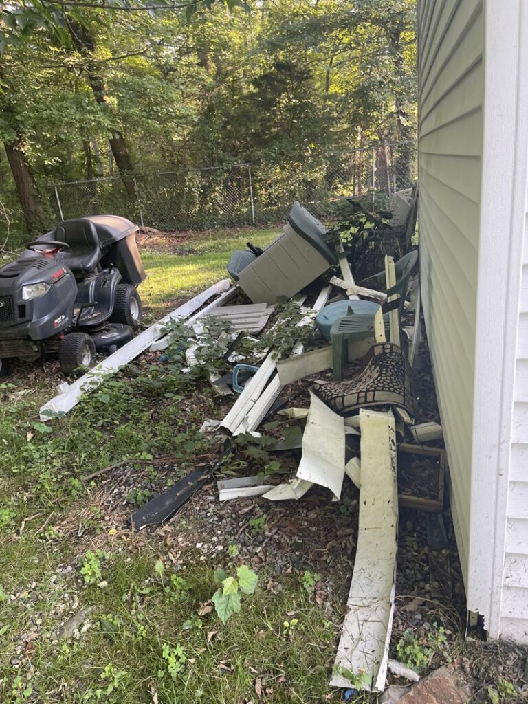 A large pile of construction debris, old furniture, and various junk items for removal by CK Junk Removal in New Bedford, MA