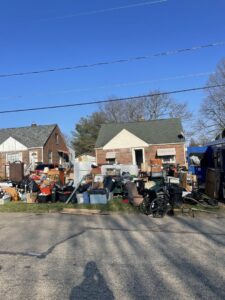 A large pile of household junk, furniture, and debris outside a house, ready for general junk removal by TRS Roll-Offs LLC in Canton, OH.