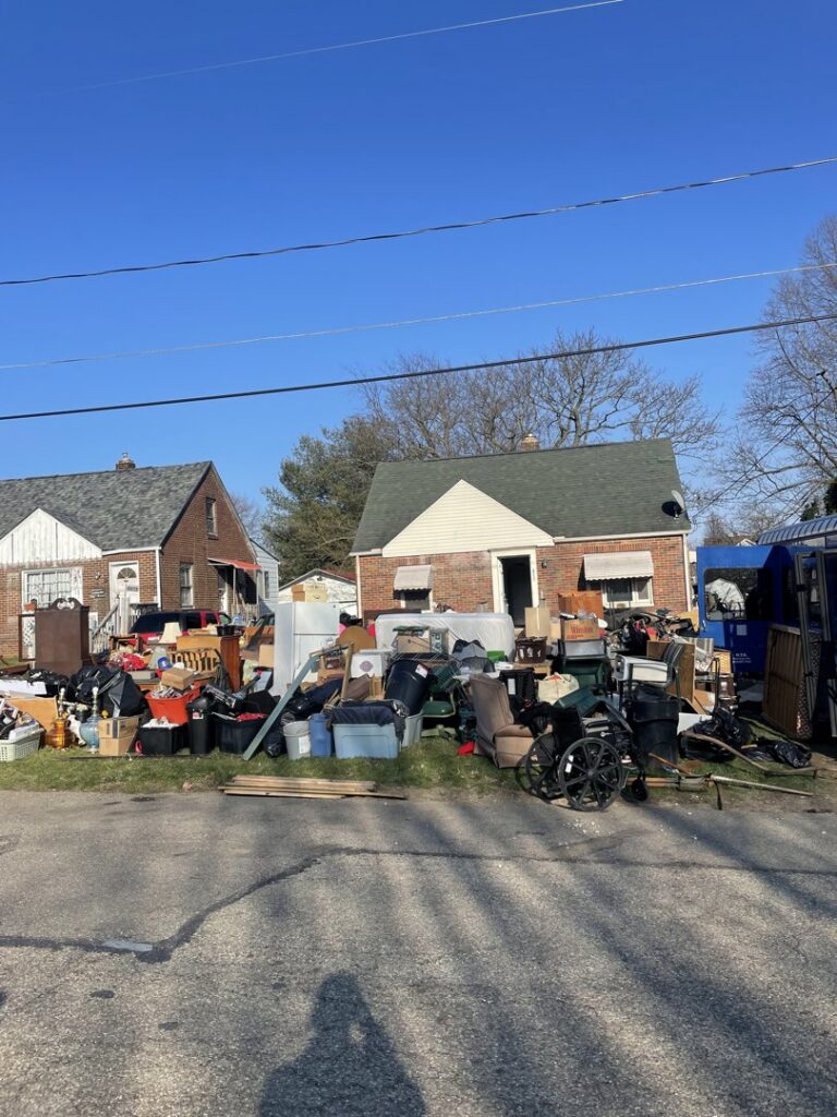 A large pile of household junk, furniture, and debris outside a house, ready for general junk removal by TRS Roll-Offs LLC in Canton, OH.