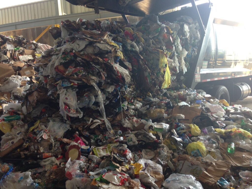 A large pile of mixed junk and waste being processed by Green Street Services in Woodbridge Township, NJ.