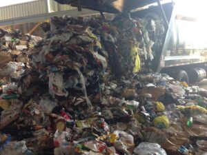 A large pile of mixed junk and waste being processed by Green Street Services in Woodbridge Township, NJ.
