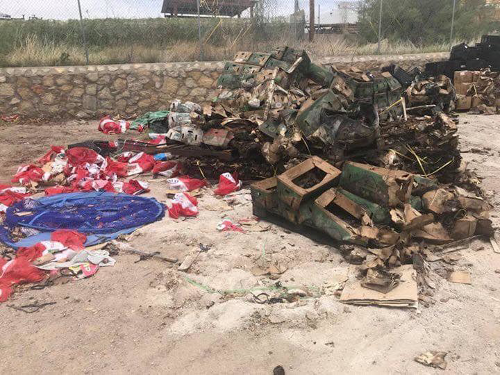 A large pile of burnt debris and damaged boxes on the ground, ready for removal by El Paso Junk Removal and Hauling in El Paso, TX.