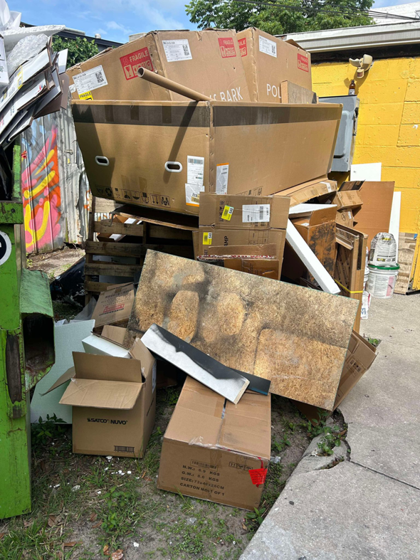 A large pile of cardboard boxes and wooden pallets ready for removal by Just Dump It in Jacksonville, FL.