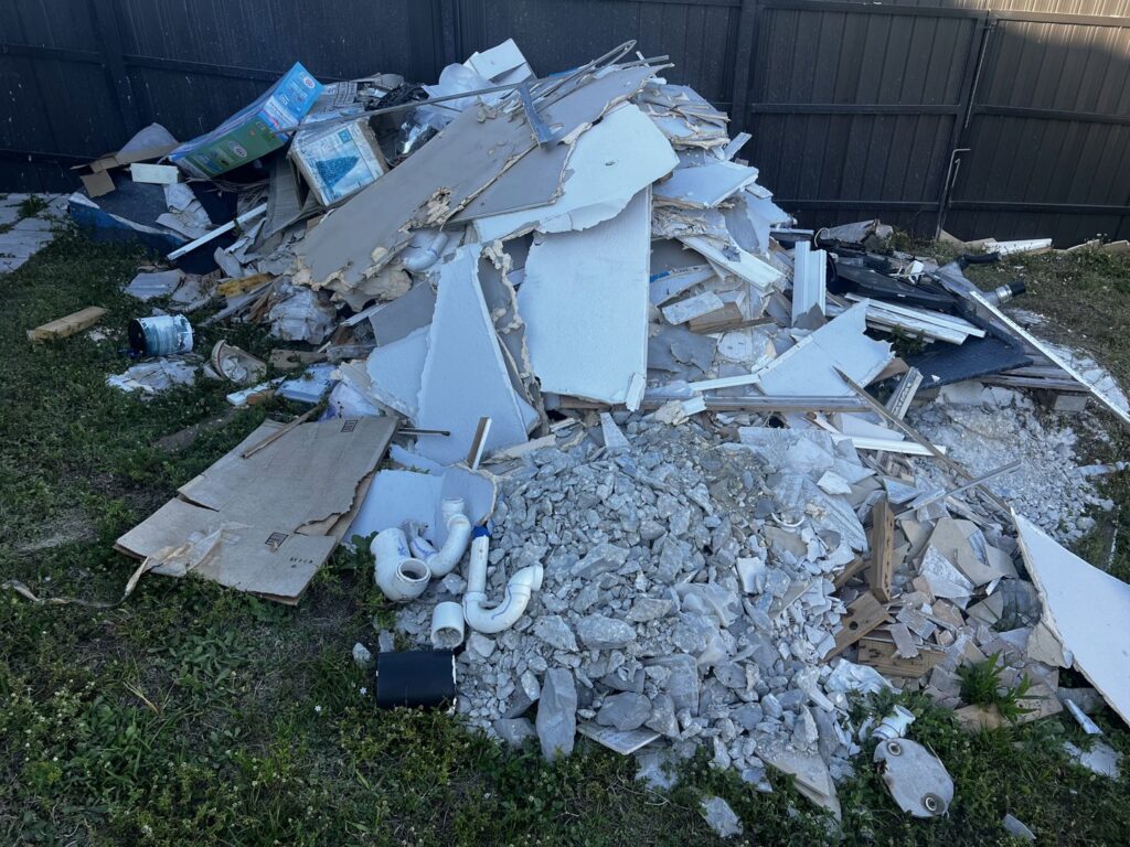 A large pile of construction debris including drywall and wood, ready for removal by Anthony's Junk Removal & Delivery LLC in Cape Coral, FL.