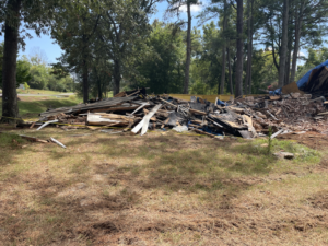 A large pile of demolition debris and junk ready for removal by Green Brothers Services in Harvest, AL