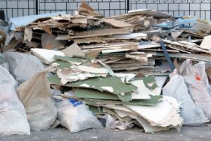 A large pile of drywall and construction waste on the ground, indicating a need for junk removal services in Sterling Heights, MI.