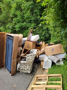 A large pile of furniture and household junk left roadside, awaiting removal by Junk Unlimited Junk Removal in Laurel, MD.
