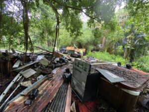 A large pile of household junk, including old electronics and metal, ready for removal by EZ Pickups Hawaii LLC in Hilo, HI.
