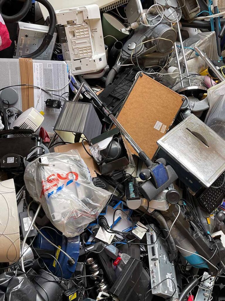 A large pile of miscellaneous household junk, including electronics, ready for removal by BumbleBee Junk in Sun Valley, CA