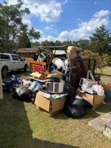 A large pile of household junk, including furniture, boxes, and appliances, ready for removal by Dumpzilla in Raleigh, NC.