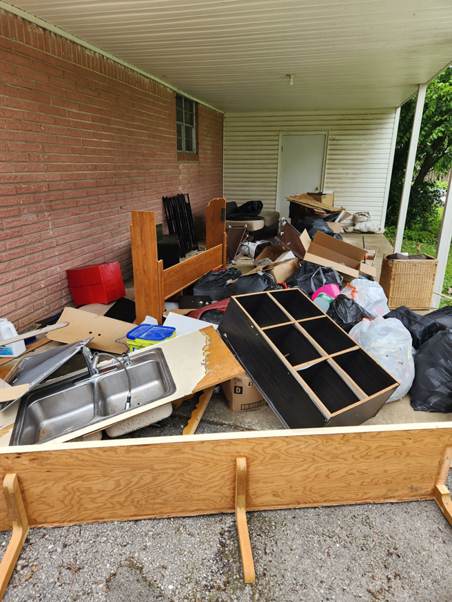 A large pile of household junk, including furniture and trash bags, awaiting removal by Urban Junk Removal, LLC in Springdale, AR.