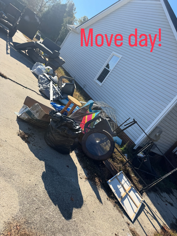 A large pile of diverse household junk and debris on a driveway, ready for move-out cleanout by Junkslingers NC in Cary, NC.