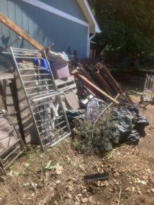 A large pile of outdoor junk including metal racks and wood ready for removal by Trash It All Hauling And Junk Removal LLC in Fort Collins, CO.