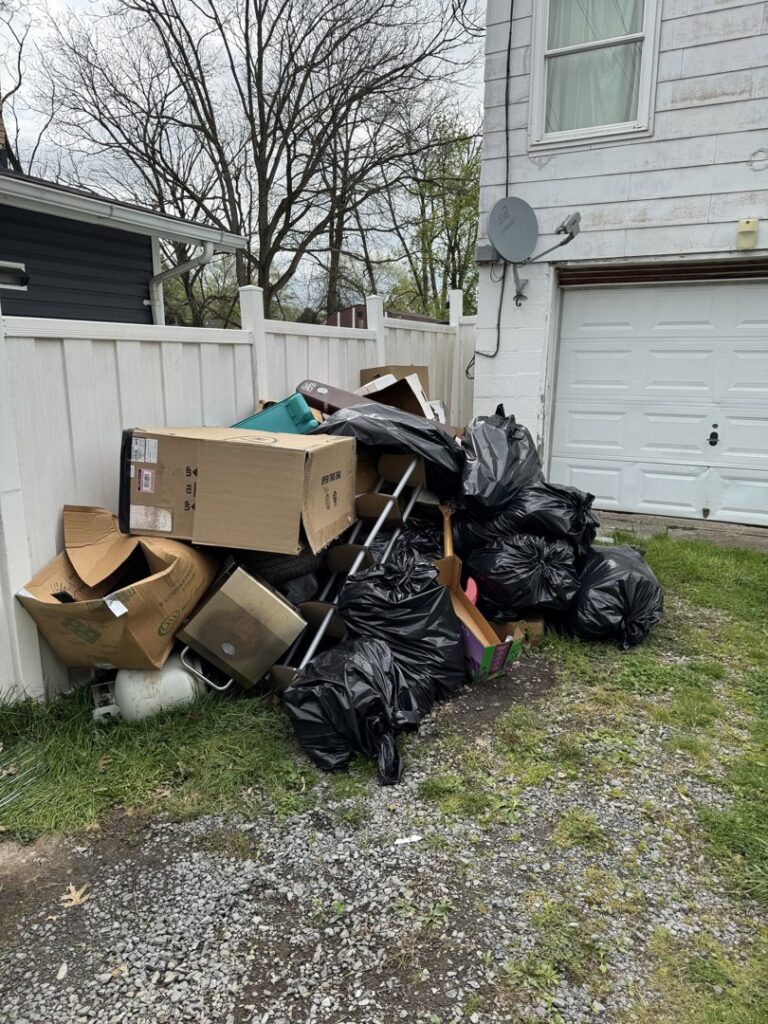 A large pile of residential junk, including trash bags and boxes, ready for removal by Trash & Dash in Houston, TX.