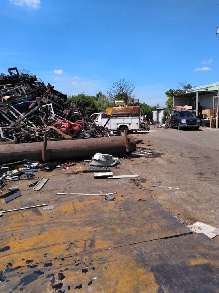 A large pile of scrap metal and various junk items at the CycleMET inc. junk removal yard in Columbus, OH.
