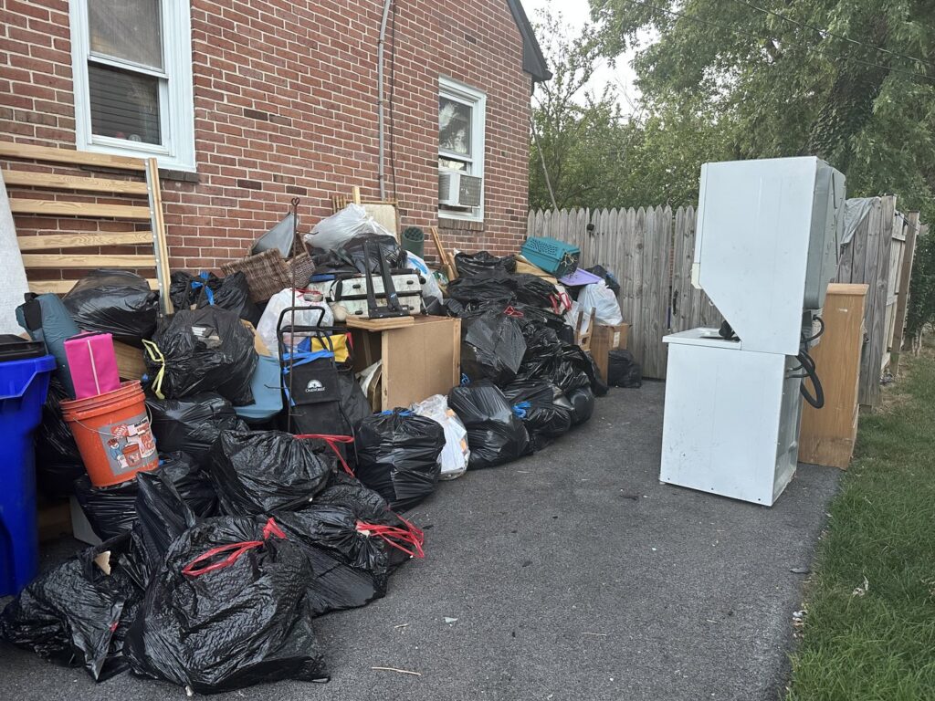 A large pile of trash bags, old appliances, and debris ready for removal by Quick Lift Junk Removal in Hagerstown, MD.