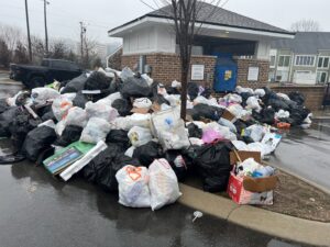 A large pile of black trash bags and assorted refuse awaiting pickup by Music City Removal in Nashville, TN.