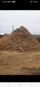 A large pile of fresh wood chips, a byproduct of tree removal services by Lp Tree Service in Janesville, WI
