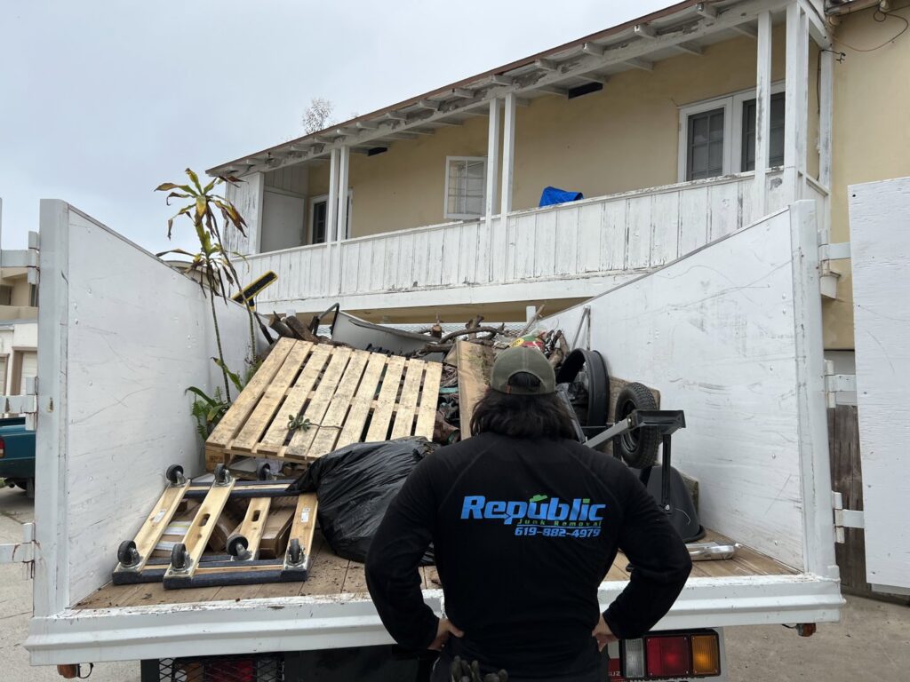 A large pile of wooden planks and debris on a tarp, ready for pickup by Republic Junk Removal in San Diego, CA.