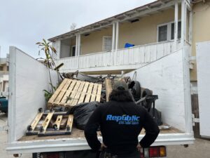 A large pile of wooden planks and debris on a tarp, ready for pickup by Republic Junk Removal in San Diego, CA.