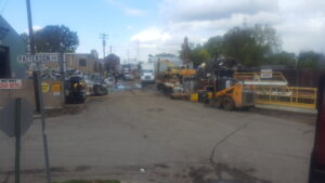 A wide view of the large recycling yard operations with heavy equipment and scrap piles at David Hirschberg Steel & Recycling Center in Cincinnati, OH.