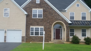 A large residential house with a stone and stucco exterior completed by Just Us Construction Inc in Philadelphia, PA.