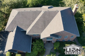Aerial view of a large residential house with a newly installed roof by Lion Roofing Corporation in Des Plaines, IL