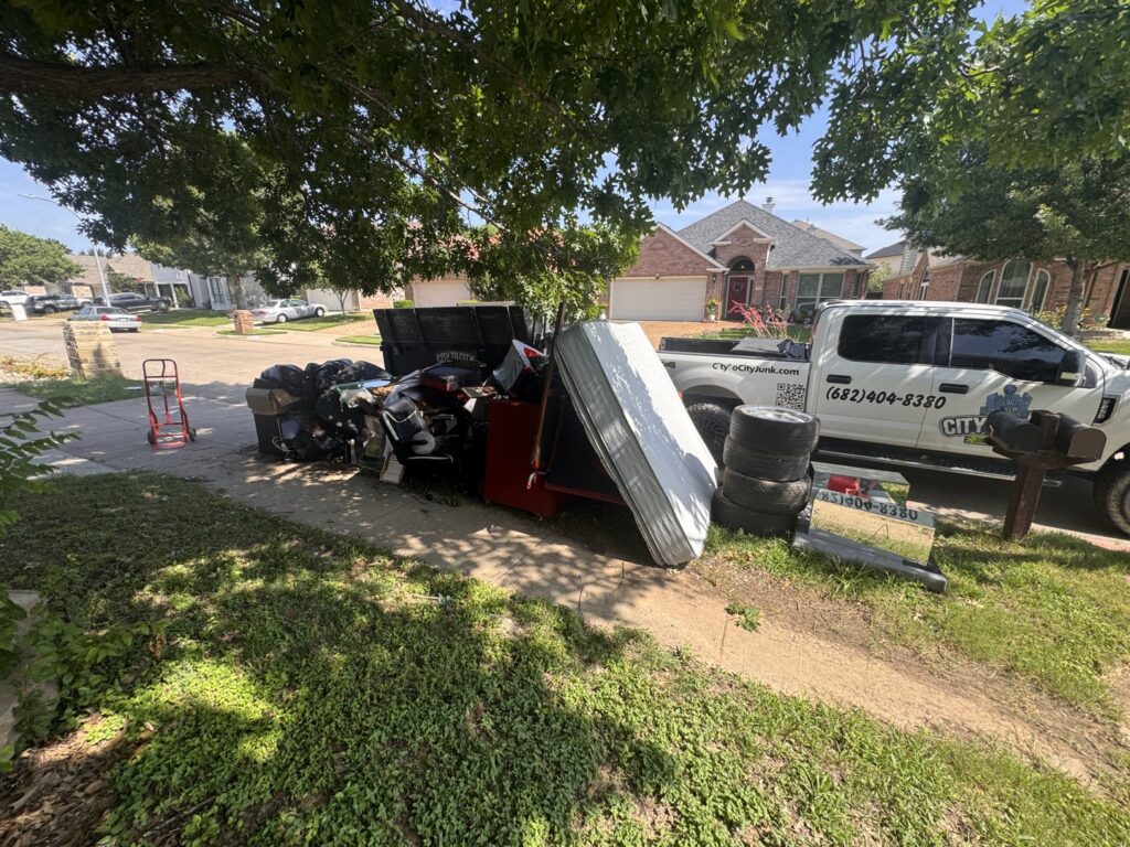 A large pile of residential junk including a mattress, tires, and furniture, ready for removal by City to City Junk Removal Fort Worth, TX.
