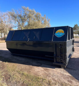 A large roll-off dumpster with the First Light Services Llc logo and contact information, available in Casper, WY.