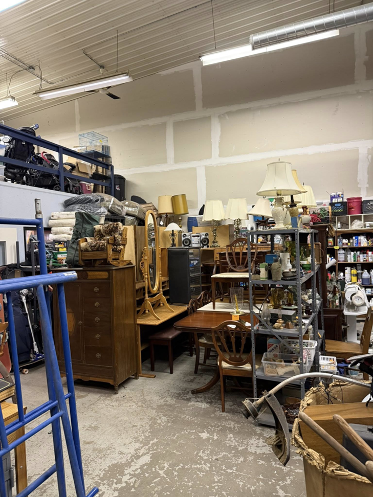 A large room filled with various furniture, lamps, and household items, ready for an estate cleanout by Kersten Family Junk Removal in Eau Claire, WI.