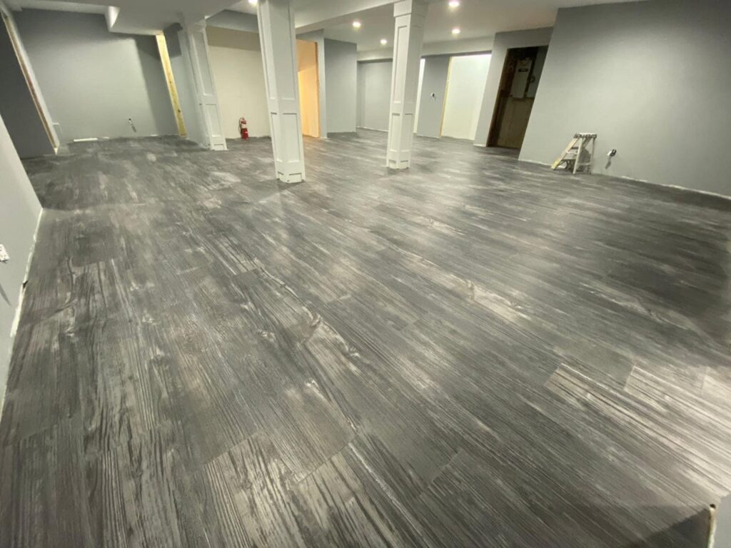 Spacious room featuring newly installed wood-look flooring by MDN Roofing 2 Flooring LLC in Fort Worth, TX.