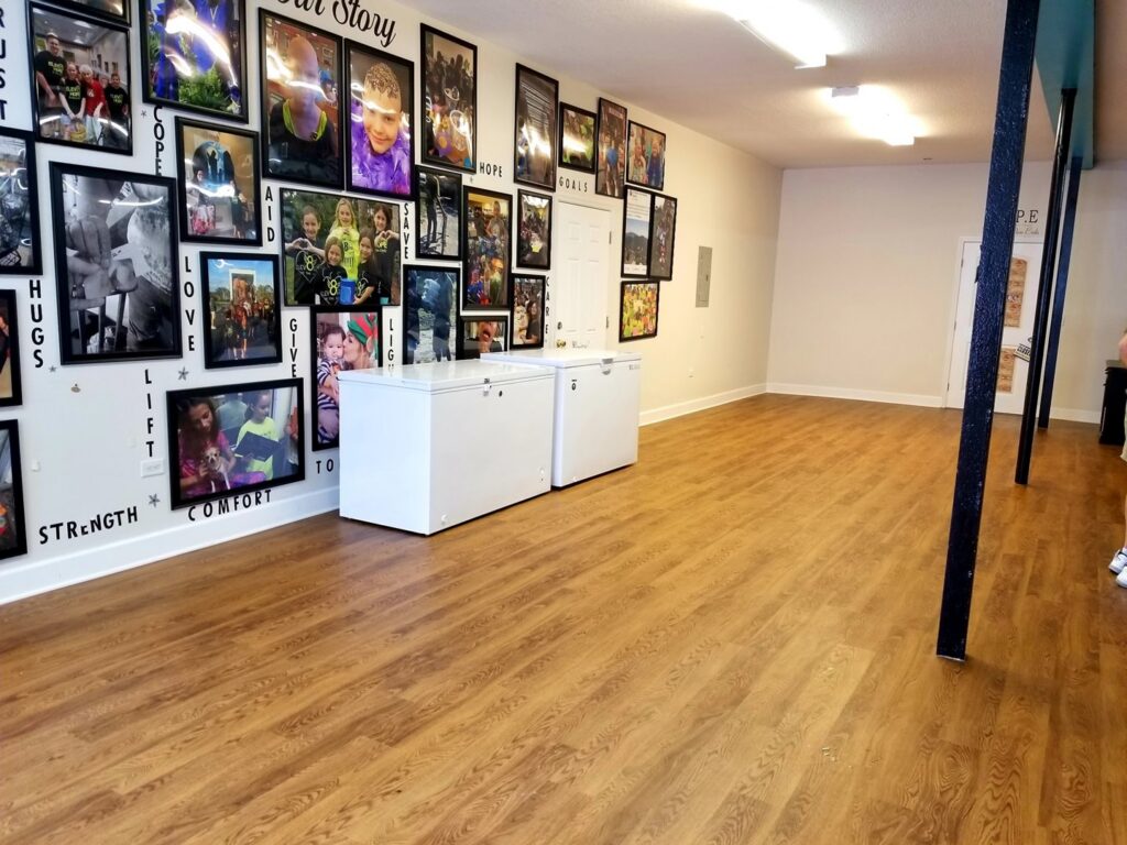 A spacious room featuring newly installed wood-look flooring, part of a renovation by Stormtroopers Home Improvement in Port St. Lucie, FL.