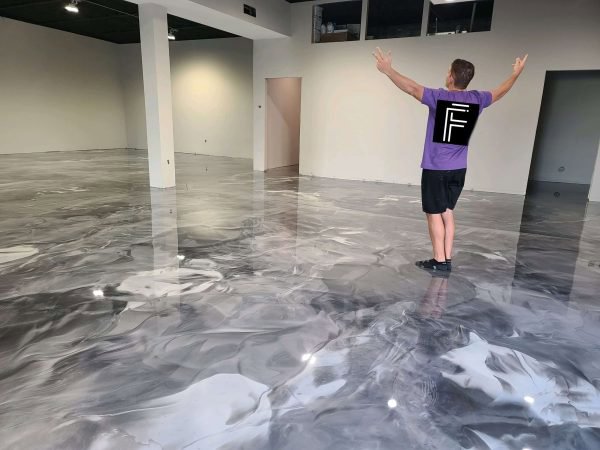 A spacious room showcasing a reflective metallic epoxy floor installed by Floor Coating Specialist in St. Petersburg, FL.
