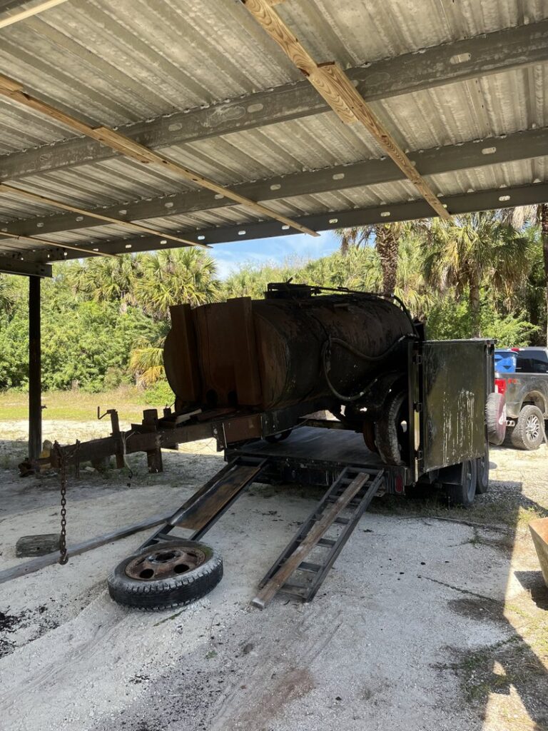 A large, rusty tank on a trailer, ready for removal by Anthony's Junk Removal & Delivery LLC in Cape Coral, FL.