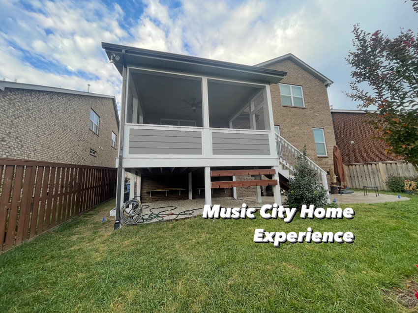 A large, multi-level screened-in porch and deck addition on a house, built by Music City Home Experience in Nashville, TN.