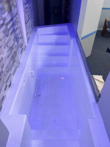 A large, white tiled baptismal pool after professional refinishing by Immaculate Refinishing in Arlington, TX.