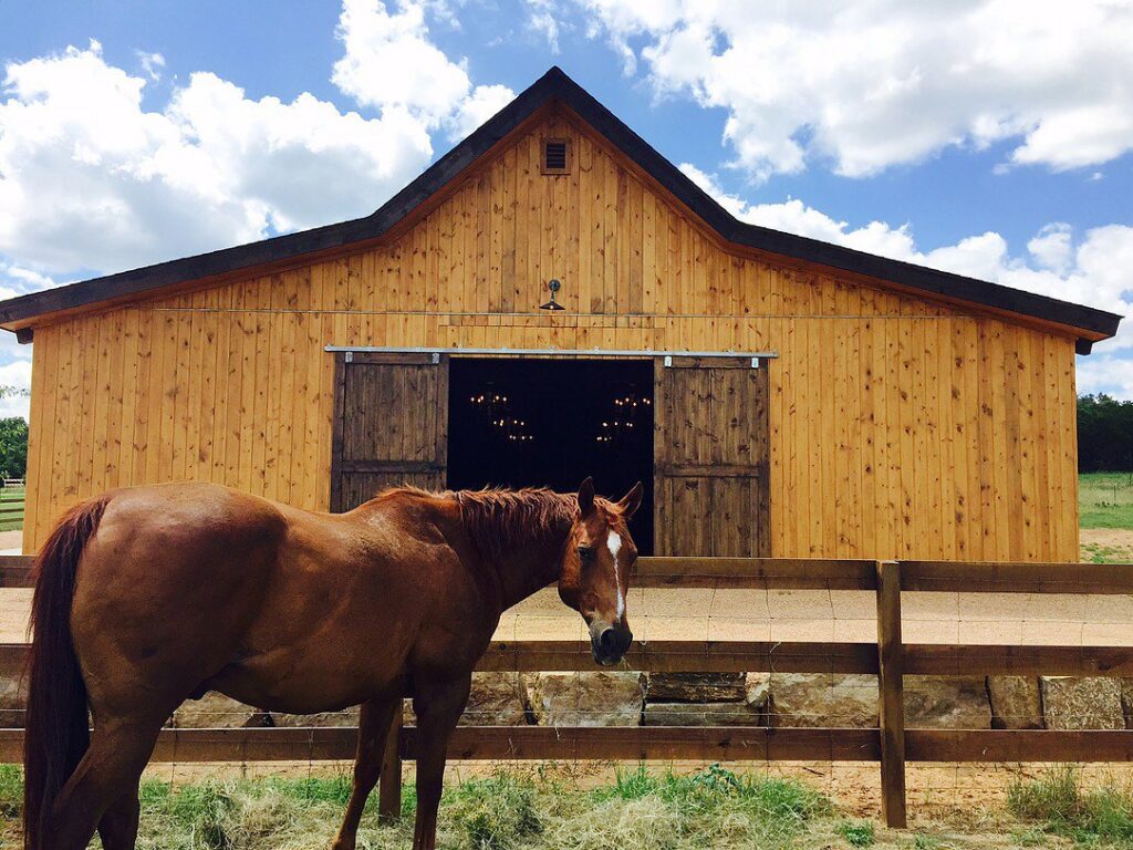 A large wooden barn, representing a construction project completed by Austin Roofing and Construction in Austin, TX.