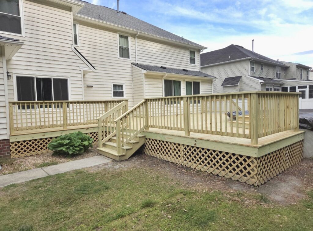 Expansive wooden deck with lattice skirting and stairs built by BOS HOME Exterior Services in Virginia Beach, VA