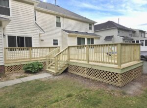 Expansive wooden deck with lattice skirting and stairs built by BOS HOME Exterior Services in Virginia Beach, VA