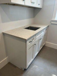 Newly installed laundry room cabinet and sink by Art of Stone Shop in Bridgeport, CT.