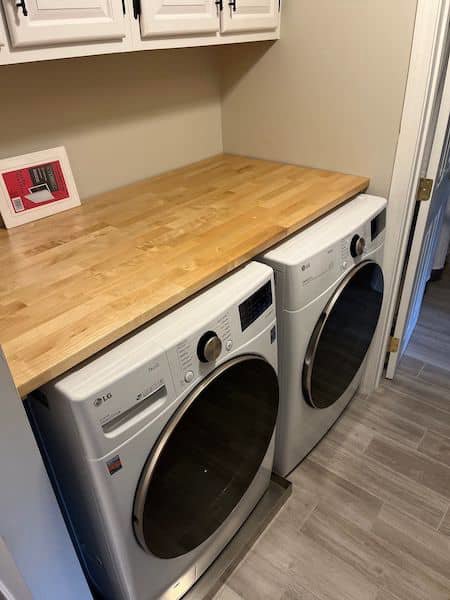 A custom wooden countertop installed over a washer and dryer by Triple M Handyman in Portsmouth, NH.