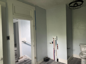 Laundry room plumbing rough-in and new door trim installation during a renovation by JW Contracting Services, LLC in Dayton, OH.