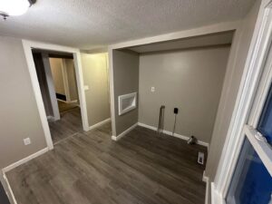 Renovated laundry room with new flooring, painted walls, and plumbing hookups by NS Construction in Imperial, CA.